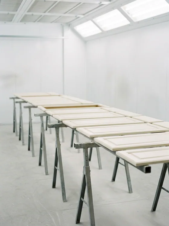 Cabinet doors laid out on trestles after finishing